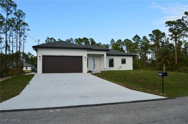 view of front of house with a garage and a front lawn