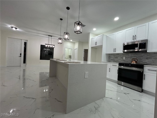 kitchen with marble finish floor, range with electric stovetop, tasteful backsplash, stainless steel microwave, and white cabinetry