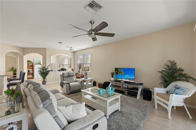 tiled living room featuring ceiling fan