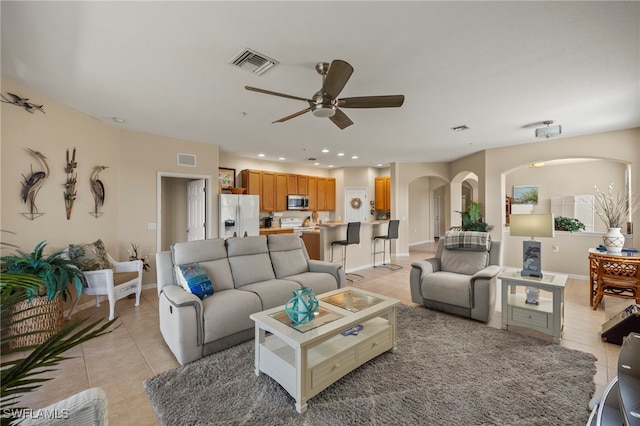 tiled living room featuring ceiling fan