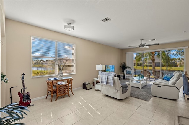 tiled living room featuring ceiling fan