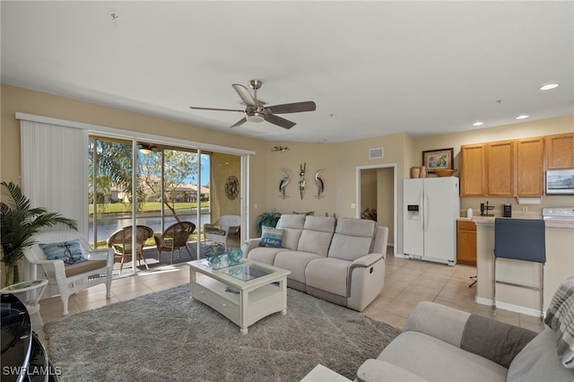 living room with light tile patterned floors and ceiling fan