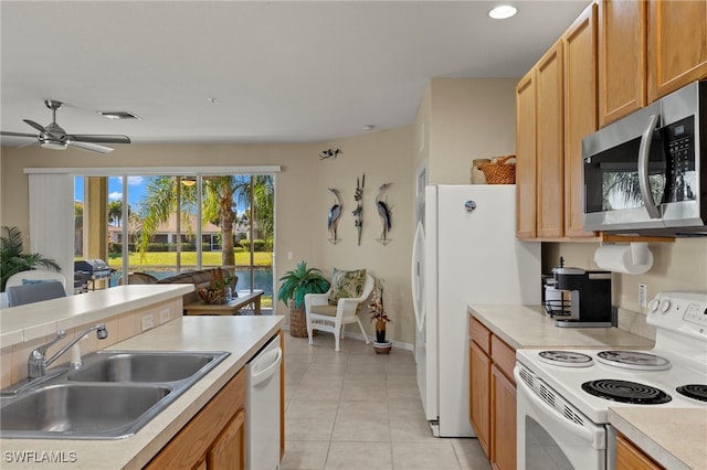 kitchen featuring sink, white appliances, ceiling fan, and light tile patterned flooring