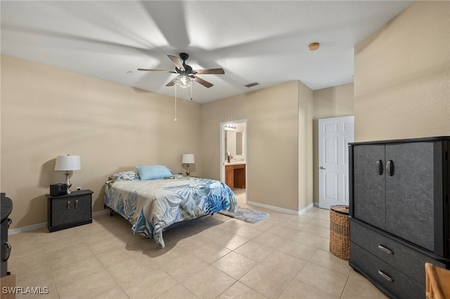 tiled bedroom with connected bathroom and ceiling fan