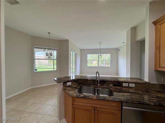 kitchen featuring light tile patterned flooring, sink, dark stone countertops, dishwasher, and kitchen peninsula