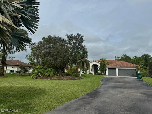 view of front of home with a garage and a front yard