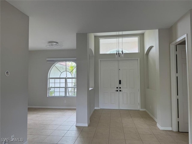 entryway featuring light tile patterned floors and a healthy amount of sunlight