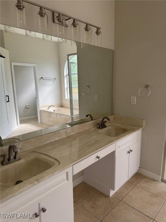 bathroom with vanity, tile patterned flooring, and a tub