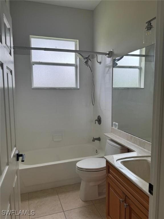 full bathroom featuring tiled shower / bath combo, vanity, tile patterned floors, and toilet