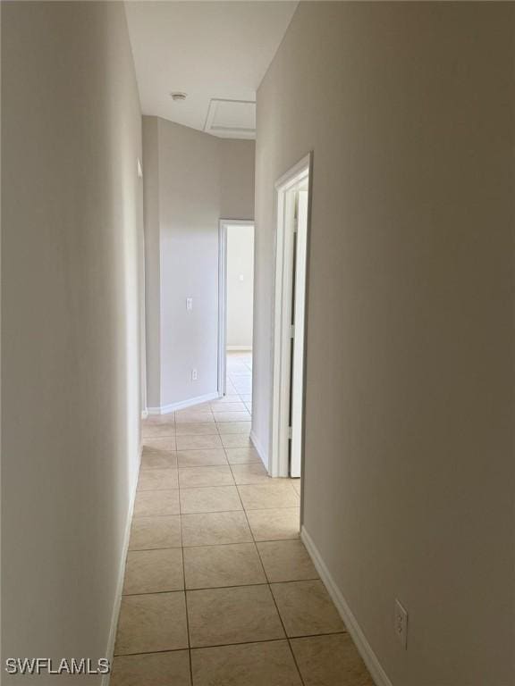 hall featuring light tile patterned floors