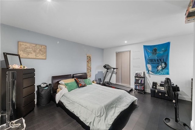 bedroom with dark hardwood / wood-style floors