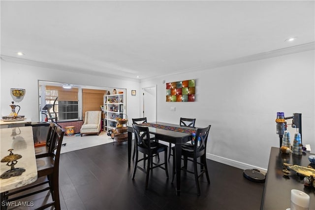 dining room featuring ornamental molding and dark hardwood / wood-style flooring