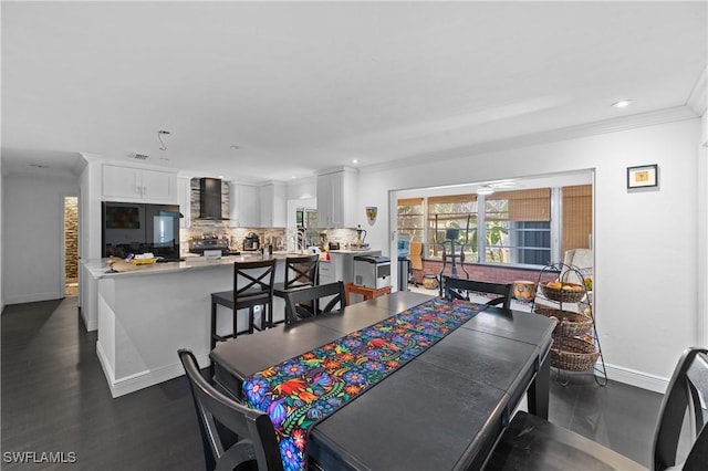 dining space with ornamental molding, dark wood-type flooring, and ceiling fan