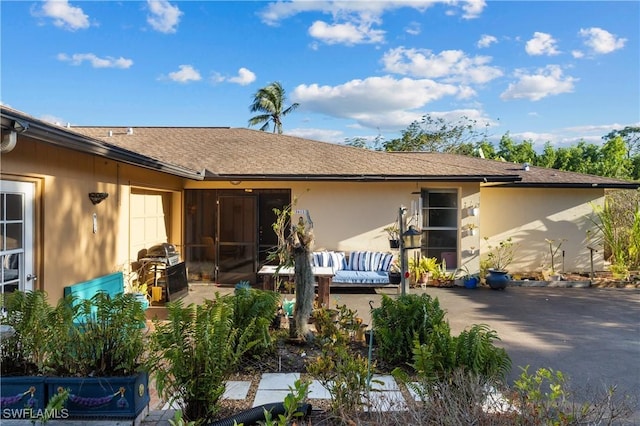 back of house featuring an outdoor living space and a patio