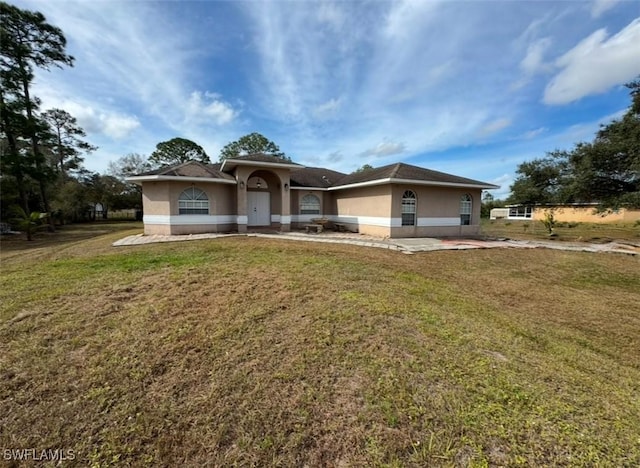 view of front facade with a patio area and a front lawn