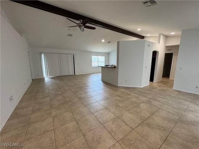 unfurnished room featuring ceiling fan, light tile patterned floors, and vaulted ceiling with beams