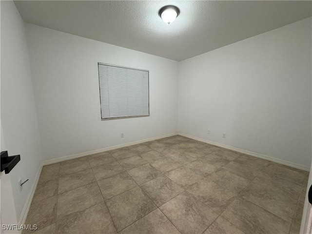 unfurnished room featuring a textured ceiling