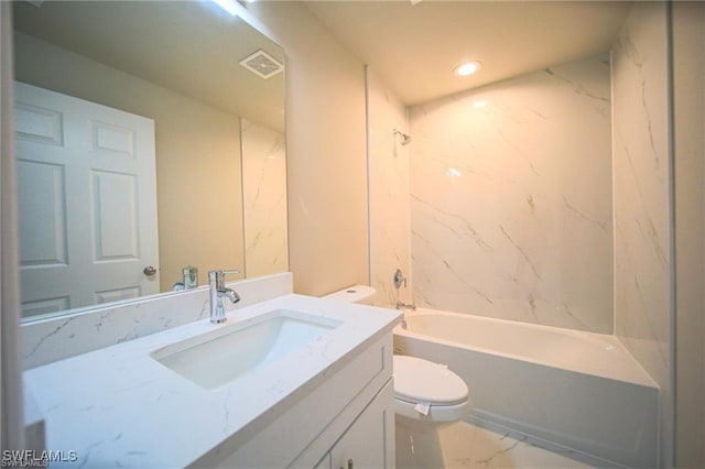 full bathroom featuring tiled shower / bath combo, vanity, and toilet