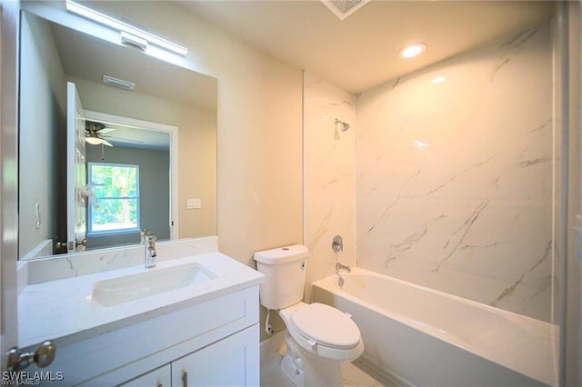 full bathroom with ceiling fan, toilet, vanity, and tiled shower / bath combo