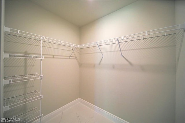 spacious closet with tile patterned floors