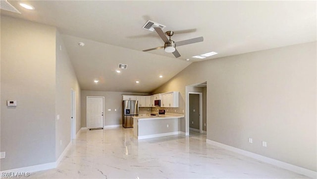 kitchen with appliances with stainless steel finishes, tasteful backsplash, white cabinets, kitchen peninsula, and lofted ceiling