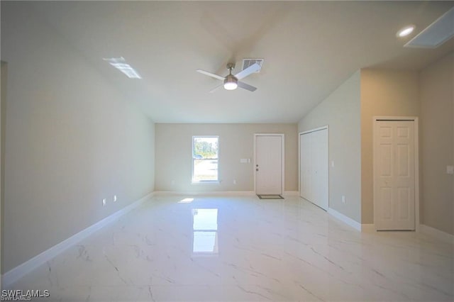 empty room featuring ceiling fan and vaulted ceiling