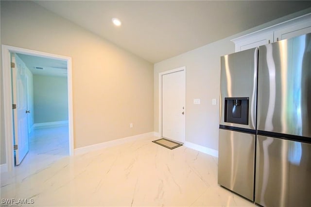 kitchen with stainless steel fridge with ice dispenser and vaulted ceiling