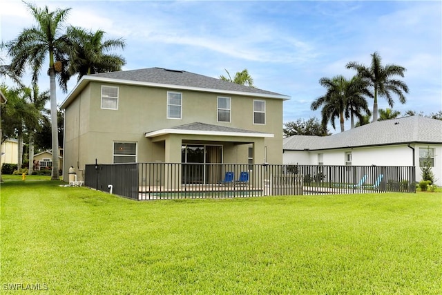 back of property featuring a yard