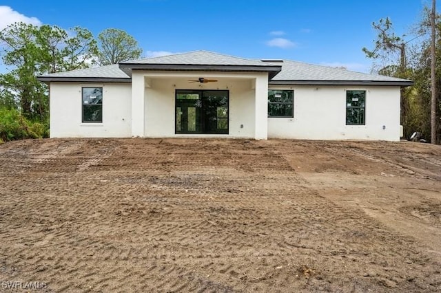 rear view of property with ceiling fan