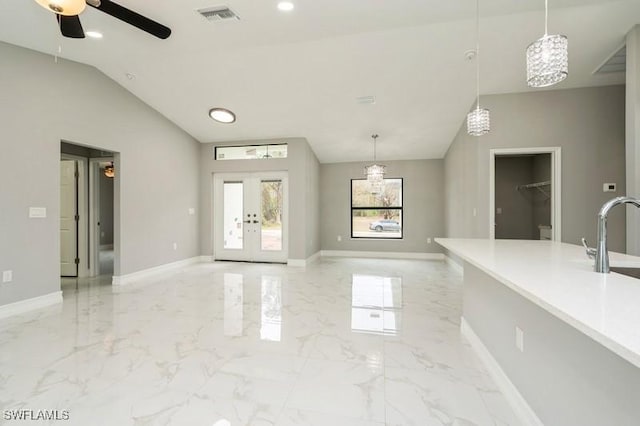 interior space with vaulted ceiling, ceiling fan, french doors, and sink