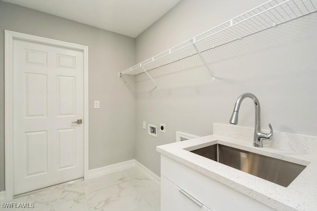 washroom with cabinets, sink, hookup for a washing machine, and hookup for an electric dryer