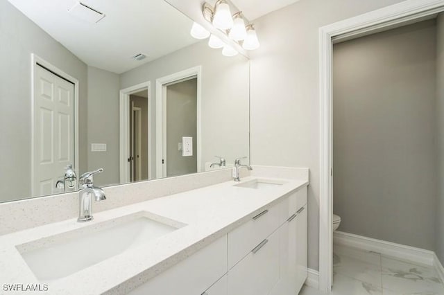 bathroom featuring toilet and vanity