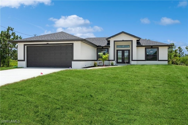 view of front of property with a garage, a front yard, and french doors