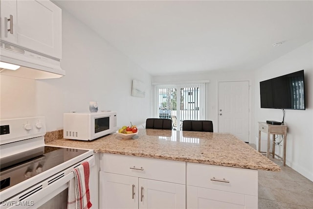 kitchen with light stone counters, white appliances, and white cabinets