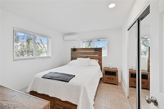 tiled bedroom featuring a closet and an AC wall unit