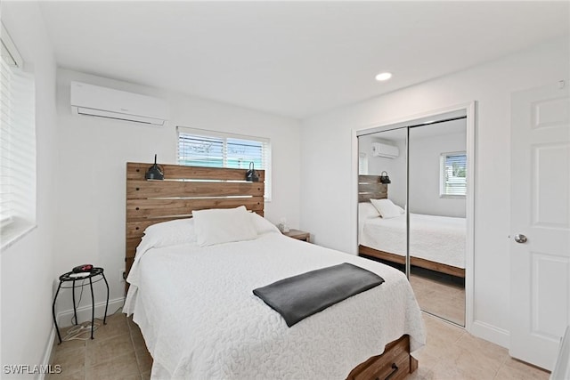 tiled bedroom featuring a closet and a wall mounted AC