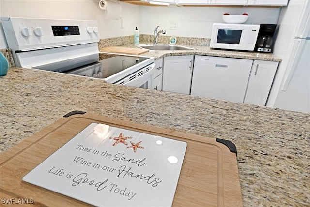 kitchen with white cabinetry, white appliances, and sink