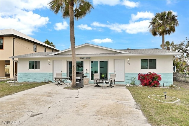 back of house with a yard and a patio area