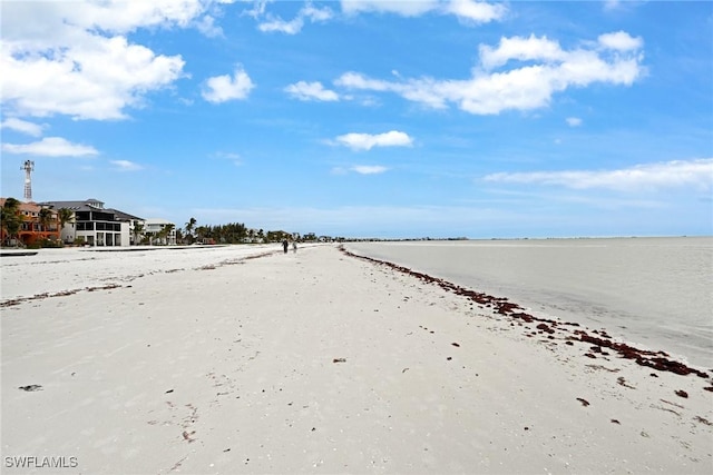 view of road featuring a water view and a beach view