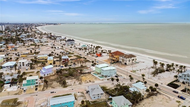 drone / aerial view featuring a water view and a view of the beach