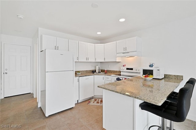 kitchen with sink, white cabinets, white appliances, and kitchen peninsula