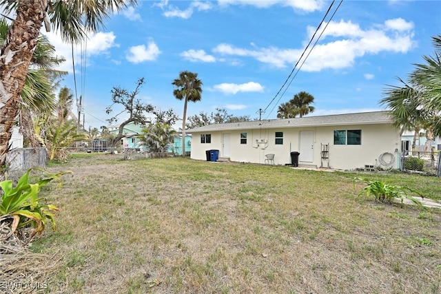 back of house featuring a yard