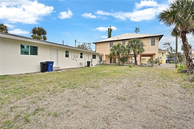 back of house featuring a yard