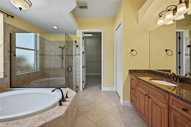 bathroom featuring vanity, separate shower and tub, and tile patterned floors