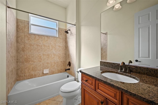 full bathroom featuring tile patterned flooring, tiled shower / bath, vanity, and toilet