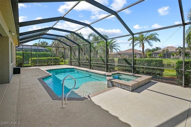 view of pool with an in ground hot tub, a patio area, and glass enclosure