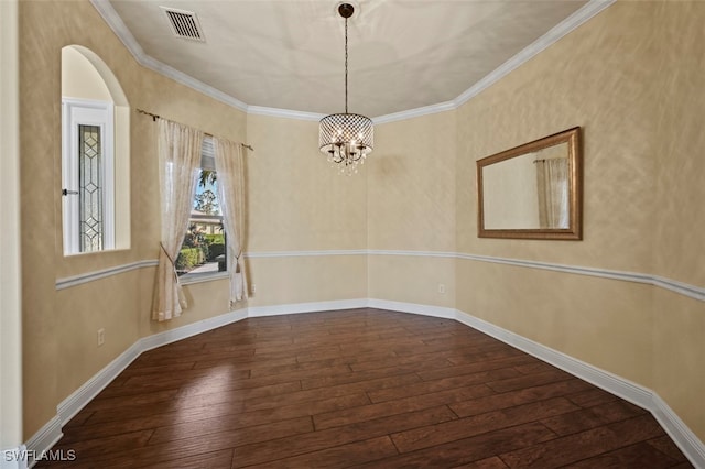 unfurnished room featuring crown molding, hardwood / wood-style flooring, and a chandelier