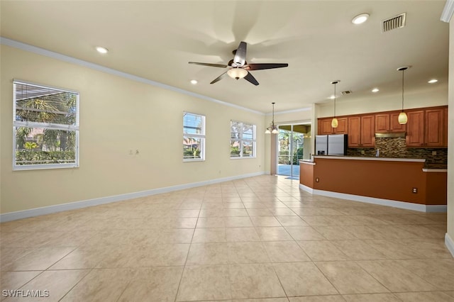 unfurnished living room with ornamental molding, light tile patterned floors, and ceiling fan