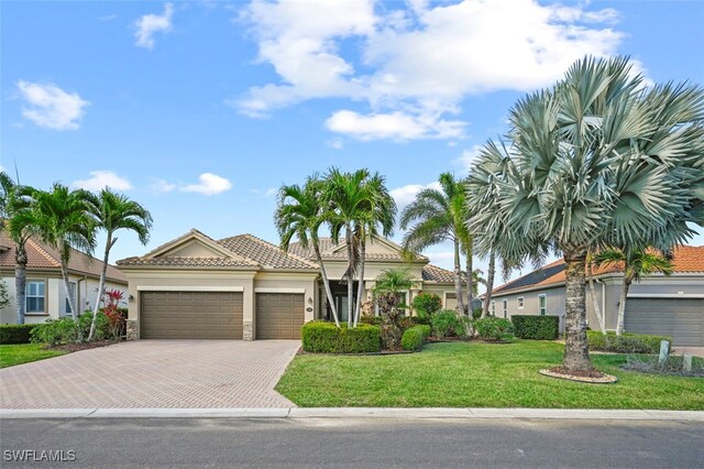 mediterranean / spanish house with a garage and a front yard