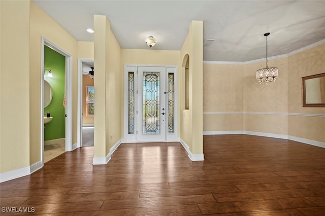 foyer entrance with dark wood-type flooring and a chandelier